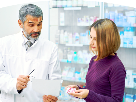 a male pharmacist with a female customer